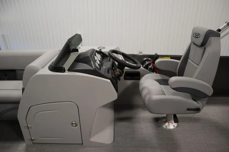 Slide: The Image of 2025 Bentley Pontoons 243 Cruise XL Tri-Toon helm with modern steering and comfortable captain's chair. - 18