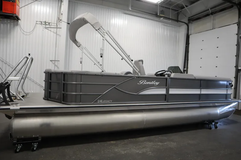 The Image of 2025 Bentley Pontoons 243 Cruise XL Tri-Toon in showroom, sleek design, gray and white finish. - 2