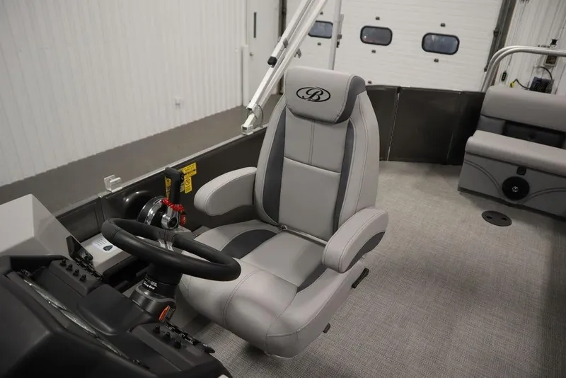 Slide: The Image of 2025 Bentley Pontoons 243 Cruise XL Tri-Toon interior with captain's chair and steering wheel. - 33