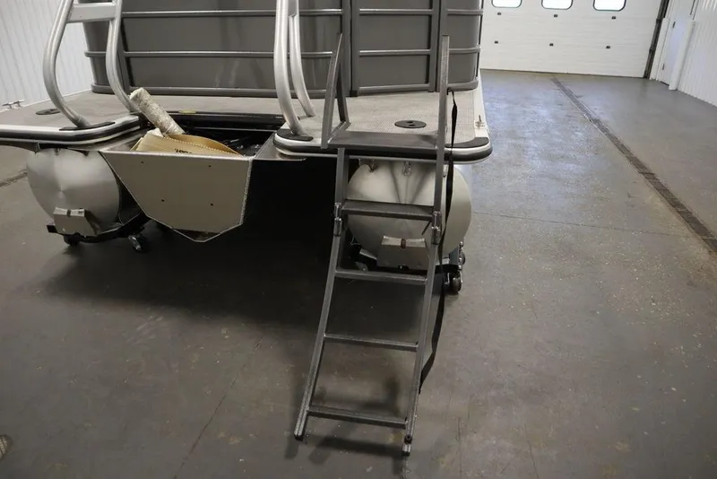 Slide: The Image of 2025 Bentley Pontoons 243 Cruise XL Tri-Toon rear view with ladder in a garage. - 42