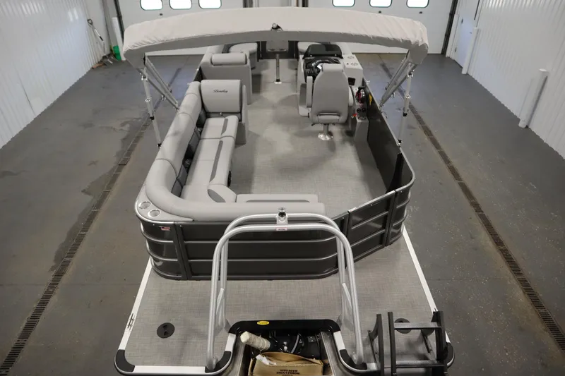 Slide: The Image of 2025 Bentley Pontoons 243 Cruise XL Tri-Toon in a garage setting. - 5