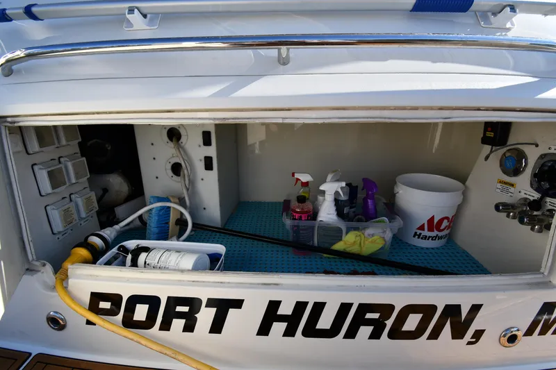 Slide: The Image of Storage compartment of 2017 Carver C37 Coupe with cleaning supplies, labeled "Port Huron, MI." - 14