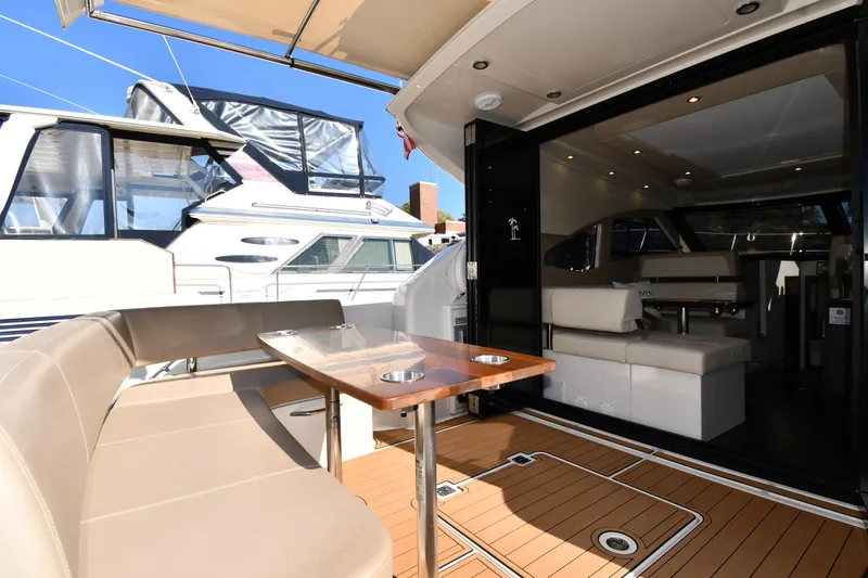 Slide: The Image of Luxurious 2017 Carver C37 Coupe yacht interior with elegant seating and dining area. - 18