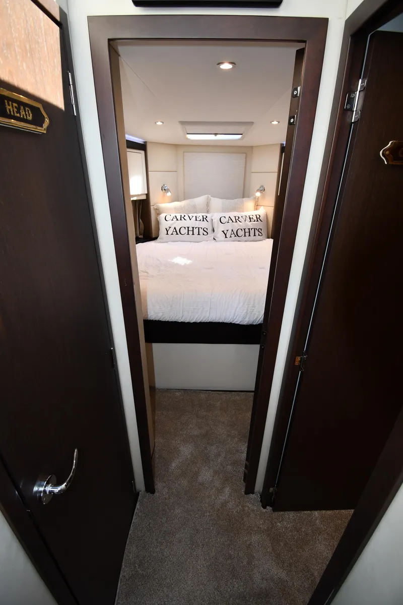 Slide: The Image of Interior of 2017 Carver C37 Coupe yacht bedroom with plush bedding. - 25