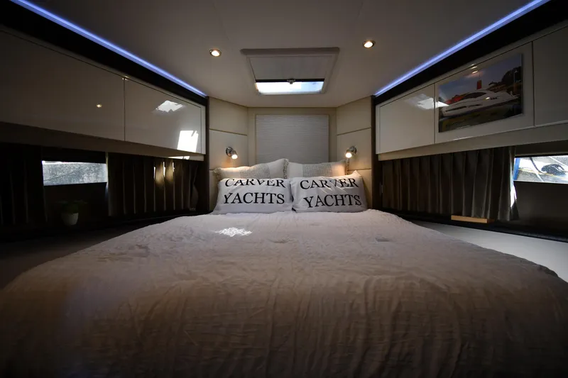 Slide: The Image of Luxurious bedroom interior of 2017 Carver C37 Coupe yacht with elegant bedding. - 26