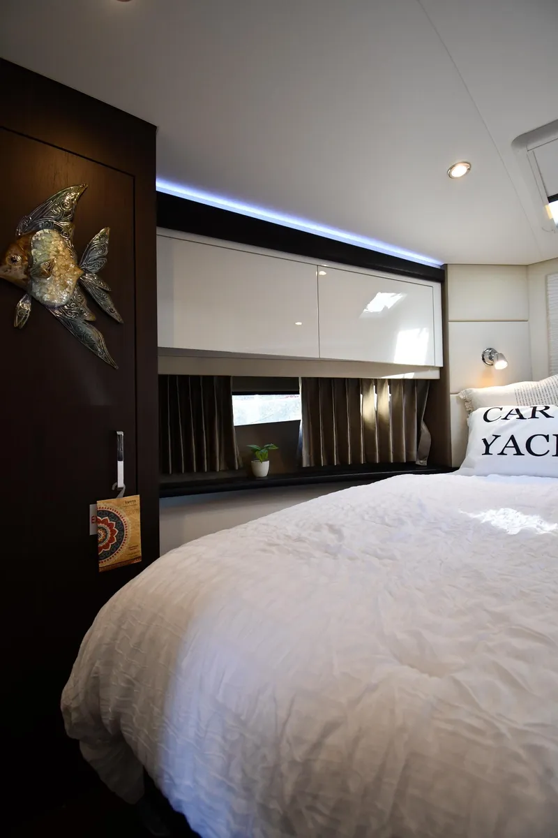 Slide: The Image of Interior of 2017 Carver C37 Coupe yacht bedroom with modern decor and cozy bedding. - 28