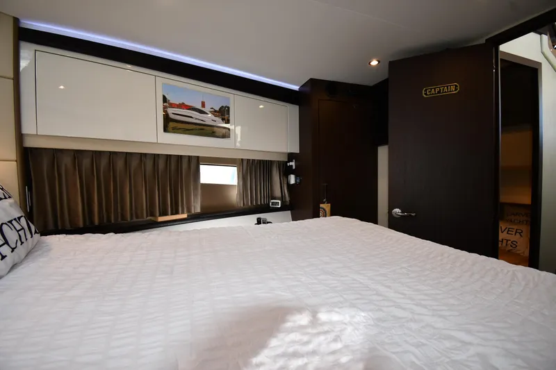 Slide: The Image of Interior of 2017 Carver C37 Coupe bedroom with modern decor and captain's door. - 30