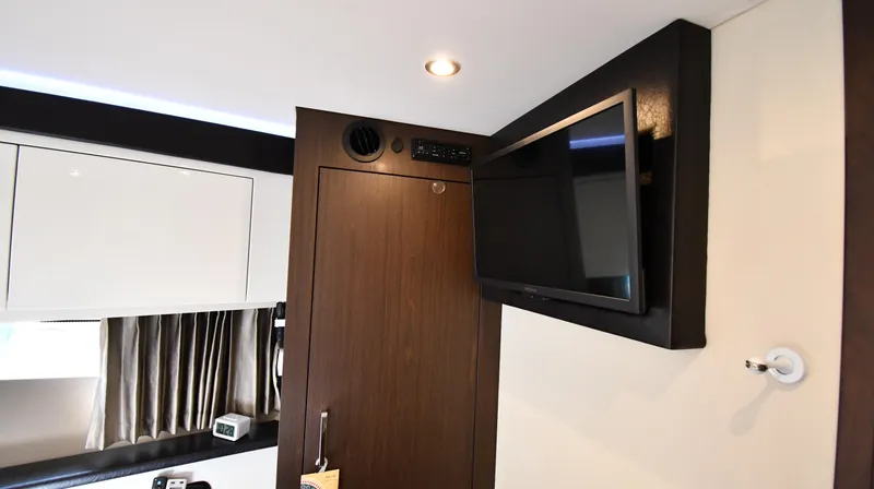 Slide: The Image of Interior of 2017 Carver C37 Coupe with mounted TV and modern cabinetry. - 31