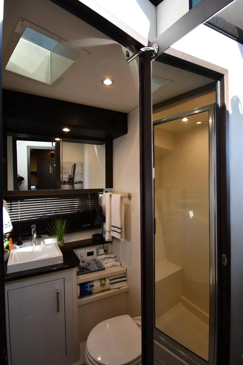 Slide: The Image of Luxurious bathroom in 2017 Carver C37 Coupe yacht with modern fixtures and ample lighting. - 32