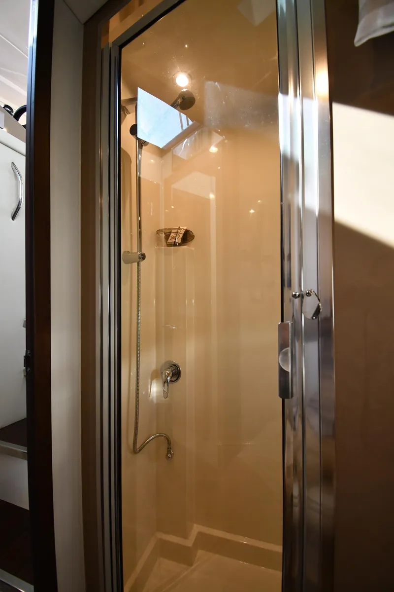 Slide: The Image of Shower area inside 2017 Carver C37 Coupe yacht, featuring modern fixtures and glass door. - 35