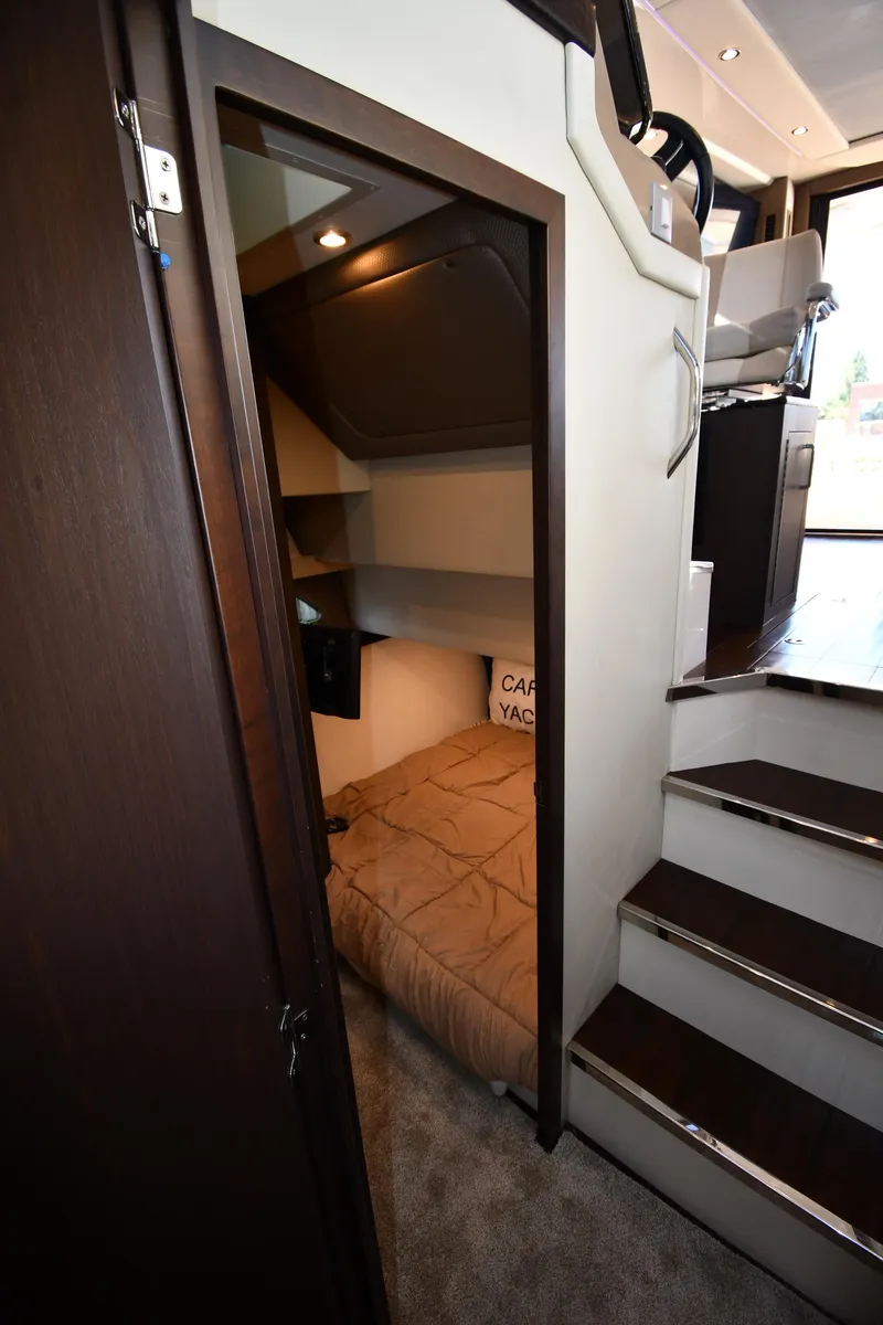 Slide: The Image of Interior of 2017 Carver C37 Coupe, featuring cozy cabin and staircase. - 36