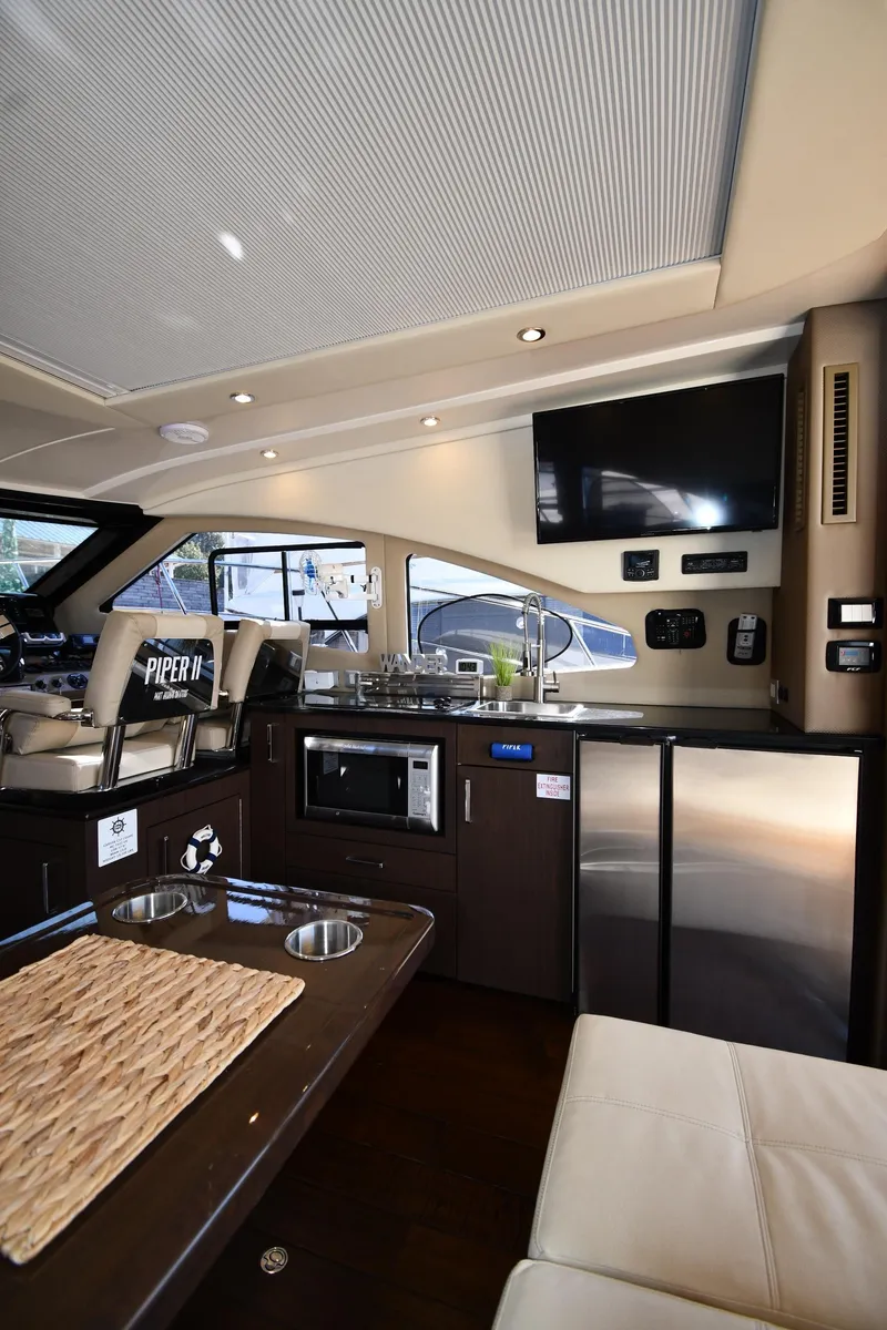 Slide: The Image of Interior of 2017 Carver C37 Coupe yacht with modern kitchen and seating area. - 41