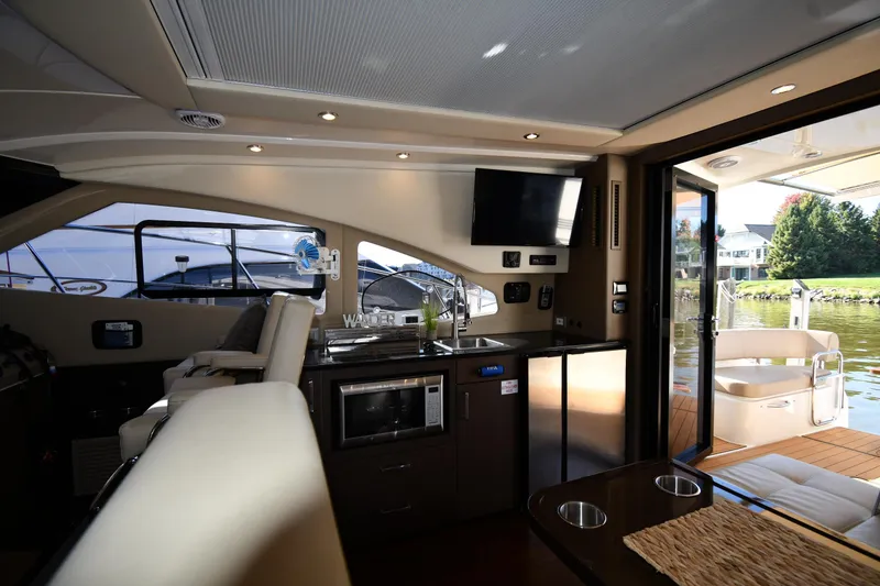 Slide: The Image of Luxurious interior of 2017 Carver C37 Coupe yacht with modern amenities and scenic water view. - 47