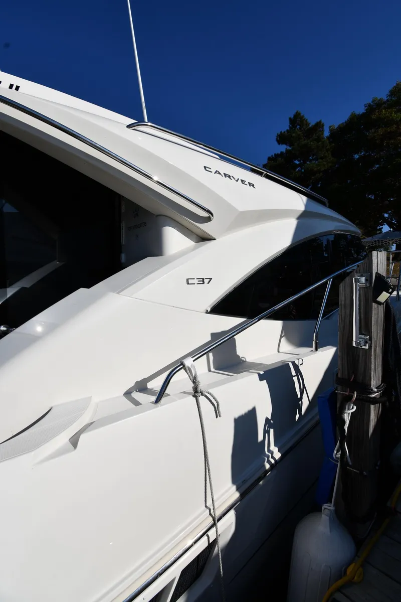 Slide: The Image of 2017 Carver C37 Coupe yacht docked, showcasing sleek design and modern features. - 5