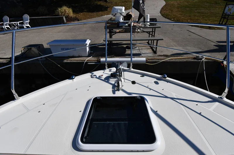 Slide: The Image of Carver C37 Coupe 2017 boat deck with railing and hatch at dock. - 6