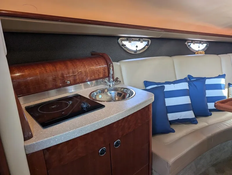 Slide: The Image of Luxurious interior of 2007 Cobalt 323 boat with kitchenette and seating area. - 11