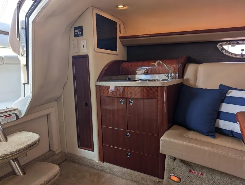Slide: The Image of Luxurious interior of 2007 Cobalt 323 boat with kitchenette and seating area. - 12