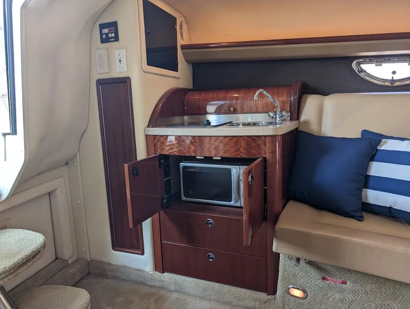 Slide: The Image of 2007 Cobalt 323 cabin interior with kitchenette, microwave, and seating area. - 13