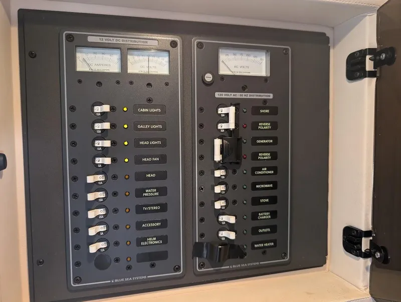 Slide: The Image of Electrical control panel in a 2007 Cobalt 323 boat, featuring various switches and meters. - 14
