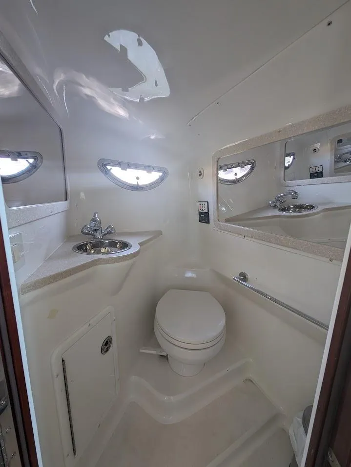 Slide: The Image of 2007 Cobalt 323 boat bathroom with sink, toilet, and mirrors. - 17