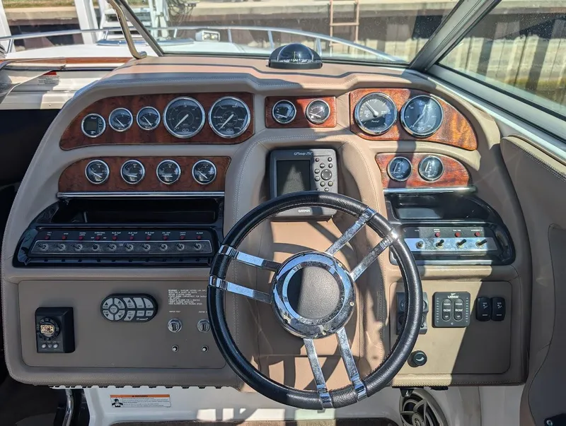 Slide: The Image of Dashboard of a 2007 Cobalt 323 boat with gauges and steering wheel. - 18