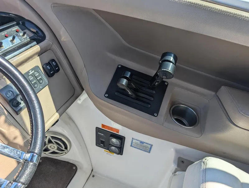 Slide: The Image of 2007 Cobalt 323 boat interior with steering wheel and control panel. - 23