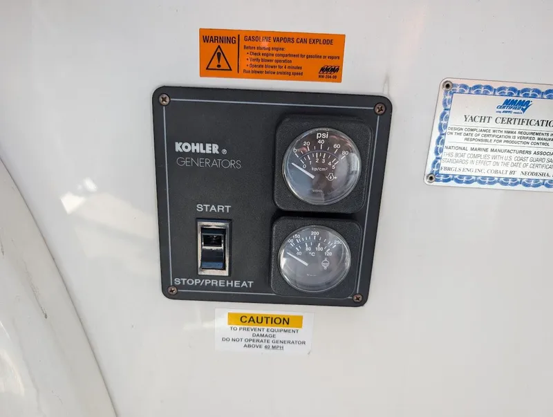 Slide: The Image of Kohler generator control panel on 2007 Cobalt 323 yacht with warning labels. - 24