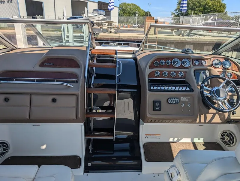 Slide: The Image of 2007 Cobalt 323 boat interior with dual consoles and steering wheel. - 26