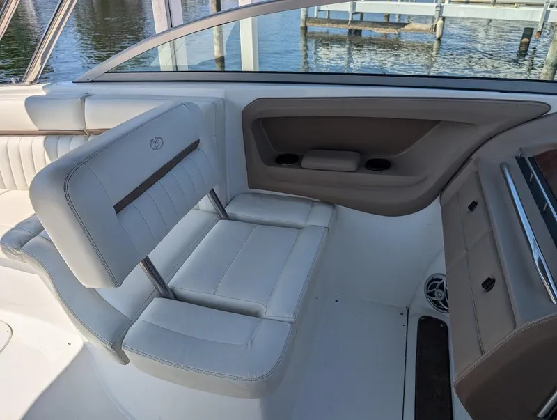 Slide: The Image of 2007 Cobalt 323 boat interior with white leather seating and water view. - 28