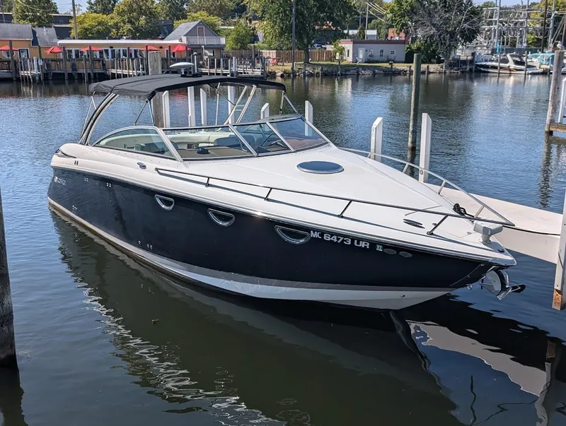 Slide: The Image of 2007 Cobalt 323 boat docked in a marina, calm water, sunny day. - 3