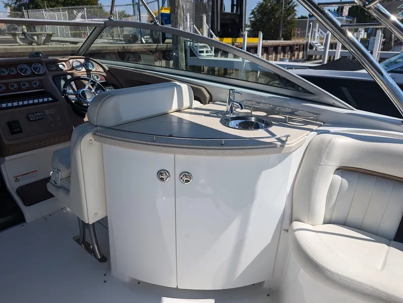 Slide: The Image of 2007 Cobalt 323 boat interior with steering wheel and sink area. - 31