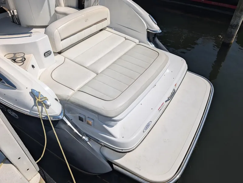 Slide: The Image of 2007 Cobalt 323 boat with white seating and swim platform, docked in water. - 41