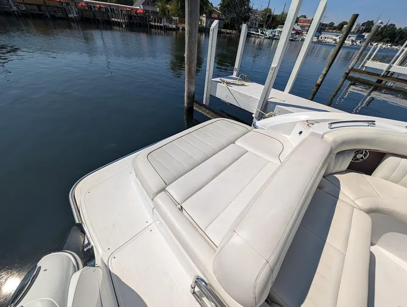Slide: The Image of 2007 Cobalt 323 boat with white leather seating docked by calm waters. - 44