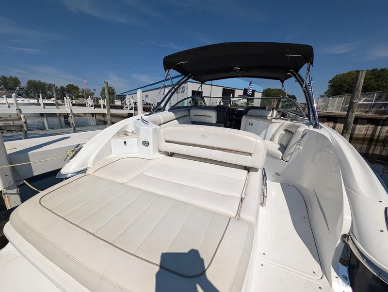 Slide: The Image of 2007 Cobalt 323 boat with white seating, docked at a marina under a clear blue sky. - 45