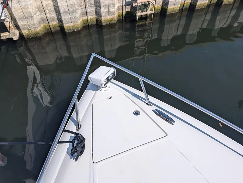 Slide: The Image of Bow of 2007 Cobalt 323 boat docked by a stone wall. - 5