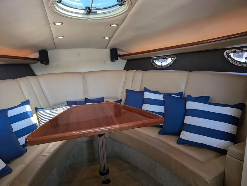 Slide: The Image of Luxurious 2007 Cobalt 323 boat interior with striped cushions and elegant wood table. - 9