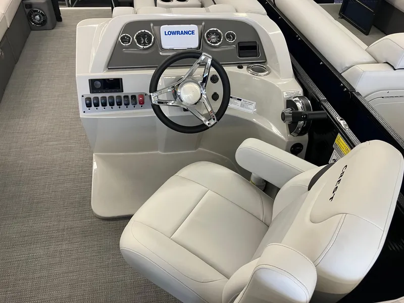 Slide: The Image of 2024 Crest 220 SLC boat helm with steering wheel and control panel. - 4