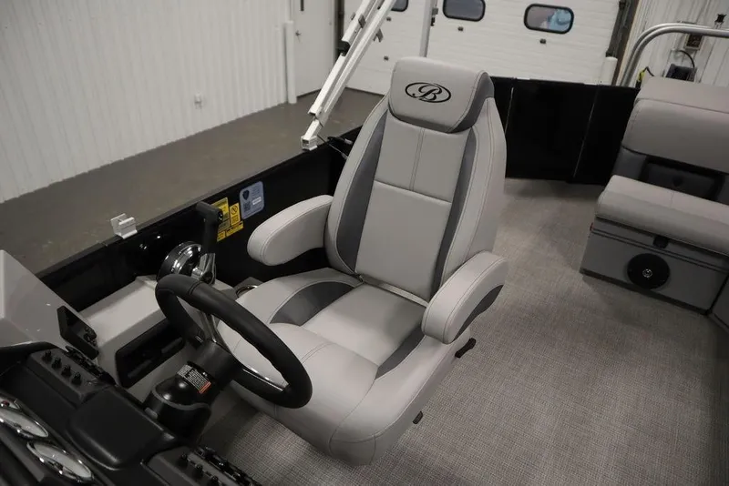 Slide: The Image of 2025 Bentley Pontoons 240 CRUISE interior with luxury captain's chair and steering console. - 27