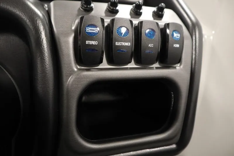 Slide: The Image of Control panel of 2025 Bentley Pontoons 240 CRUISE with labeled switches for stereo, electronics, accessories, and horn. - 30