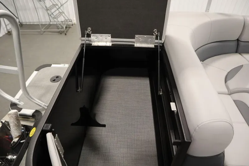Slide: The Image of 2025 Bentley Pontoons 240 CRUISE storage compartment with open lid and cushioned seating. - 43