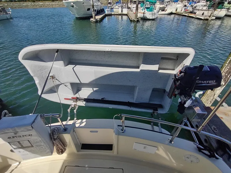 Slide: The Image of Nordic Tug 32 (2001) with dinghy and outboard motor at marina. - 10
