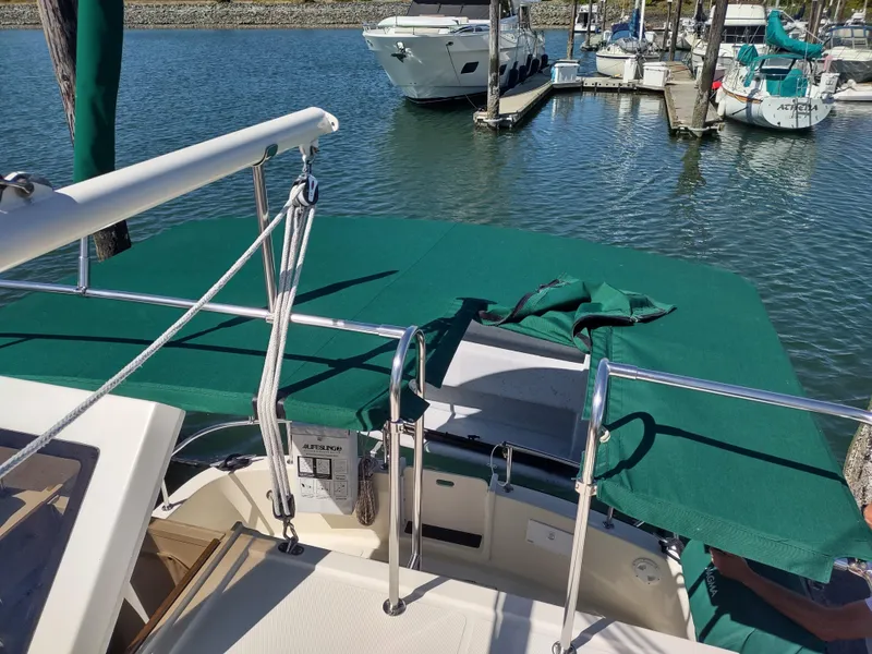 Slide: The Image of 2001 Nordic Tug 32 docked at marina with green canopy. - 17