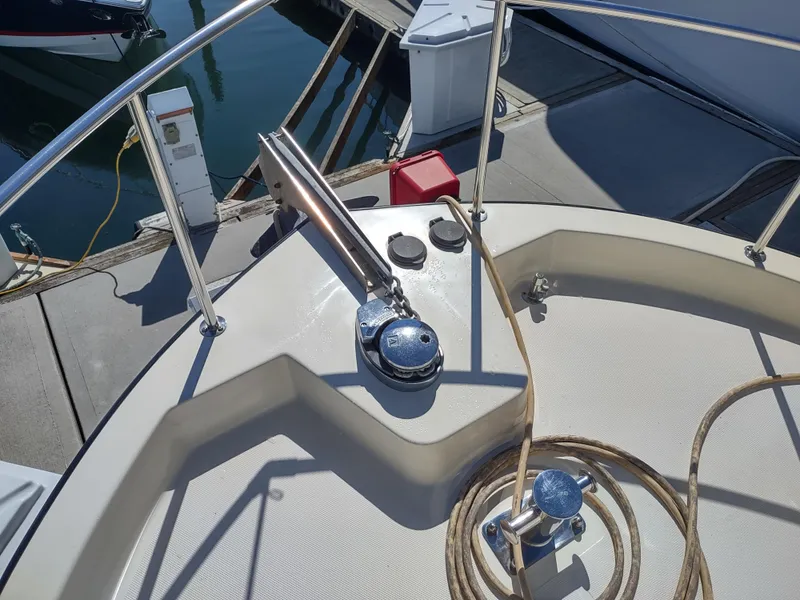 Slide: The Image of Nordic Tug 32 (2001) bow deck with winch and railing at marina. - 19