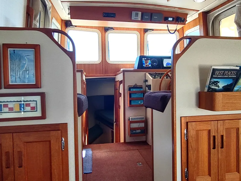 Slide: The Image of Interior of 2001 Nordic Tug 32, featuring wood cabinetry and helm station. - 28