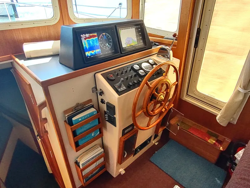 Slide: The Image of Helm of 2001 Nordic Tug 32 with wooden wheel and navigation instruments. - 30