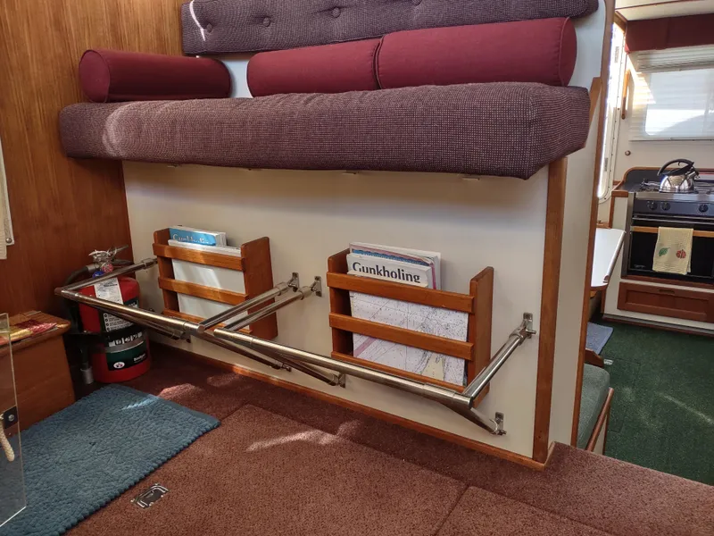Slide: The Image of Interior of a 2001 Nordic Tug 32, featuring storage racks and a cozy seating area. - 33