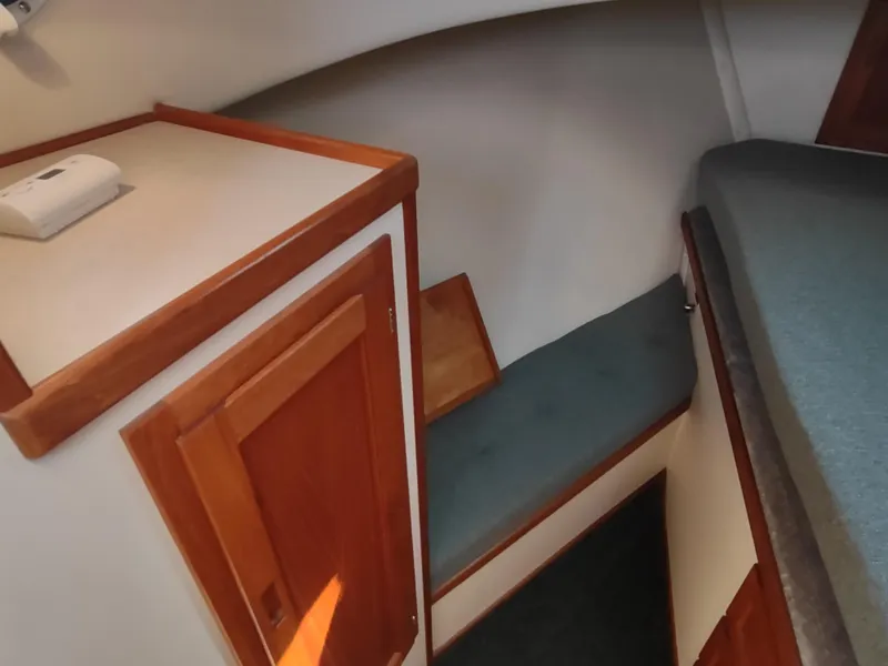 Slide: The Image of Interior of 2001 Nordic Tug 32, featuring wooden cabinetry and cozy seating area. - 40