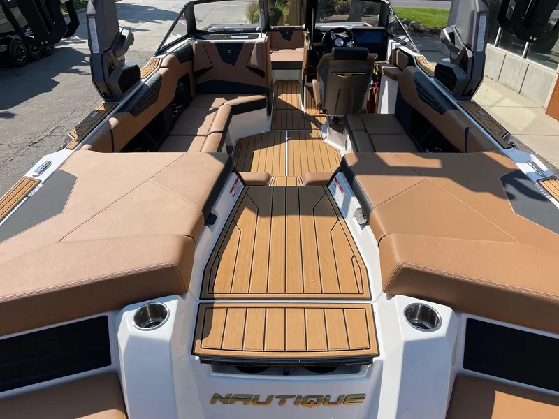 Slide: The Image of 2025 Nautique Super Air Nautique S23 interior with tan seating and sleek design. - 4