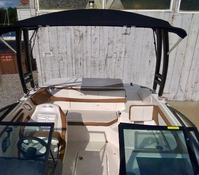 Slide: The Image of 2017 Sea Ray SPX 190 boat interior with seating and steering wheel, under a canopy. - 3