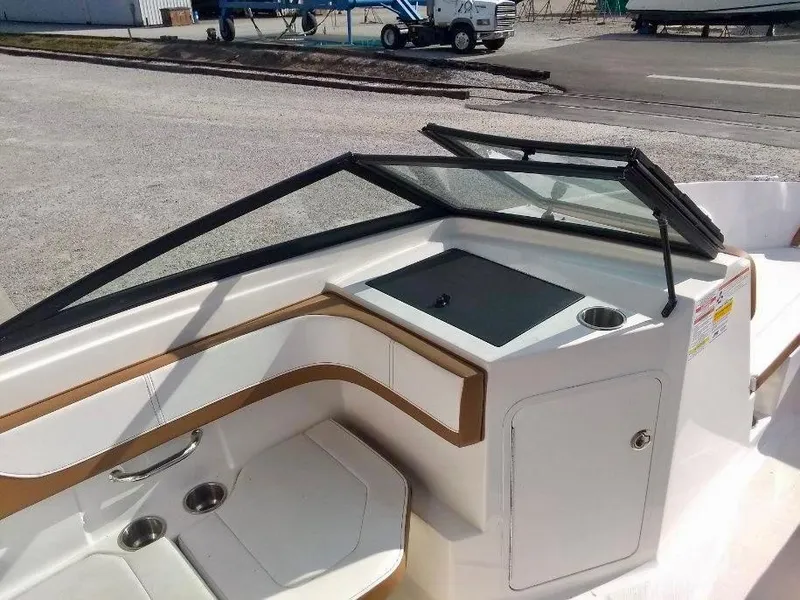 Slide: The Image of 2017 Sea Ray SPX 190 boat interior with seating and windshield, docked outdoors. - 5